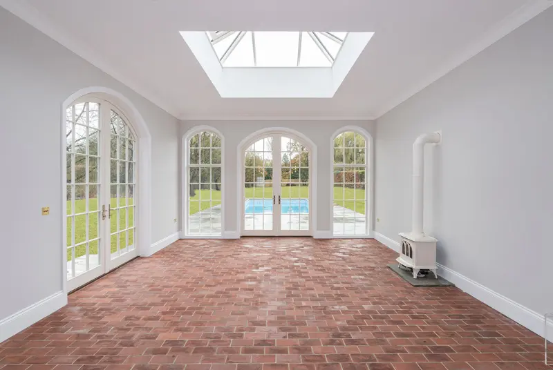 White French doors leading to a swimming pool in the garden