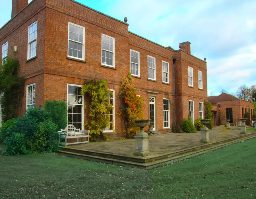 Large home with white sliding sash windows