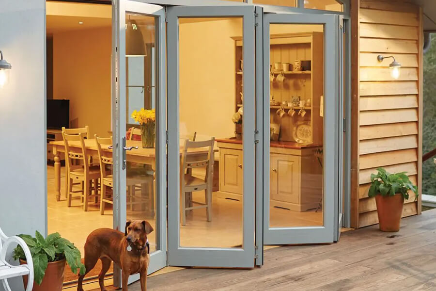 Grey bifold doors with dog standing in front