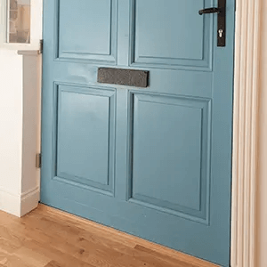 Close up of bottom half of a blue entrance door