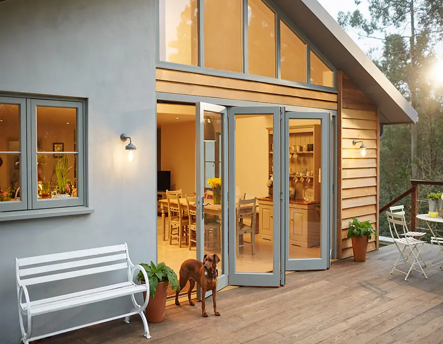 Opened bi-fold doors with dog standing in front