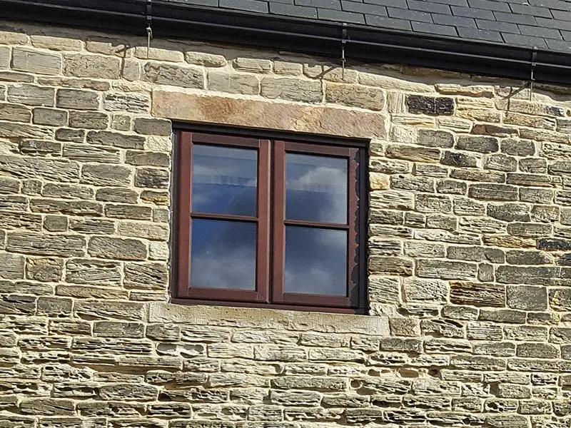 dark stained lipped casement windows