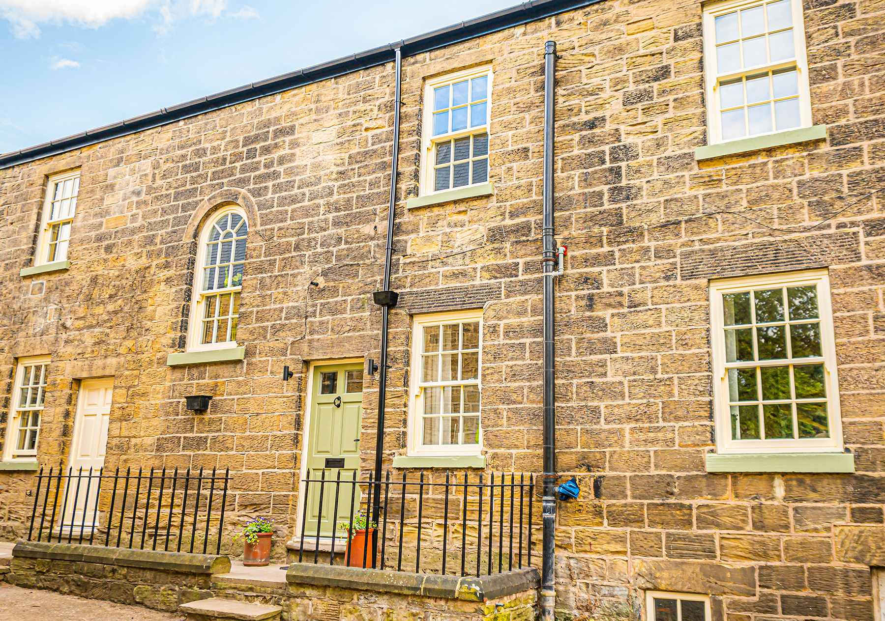 Sliding sash windows and a green entrance door