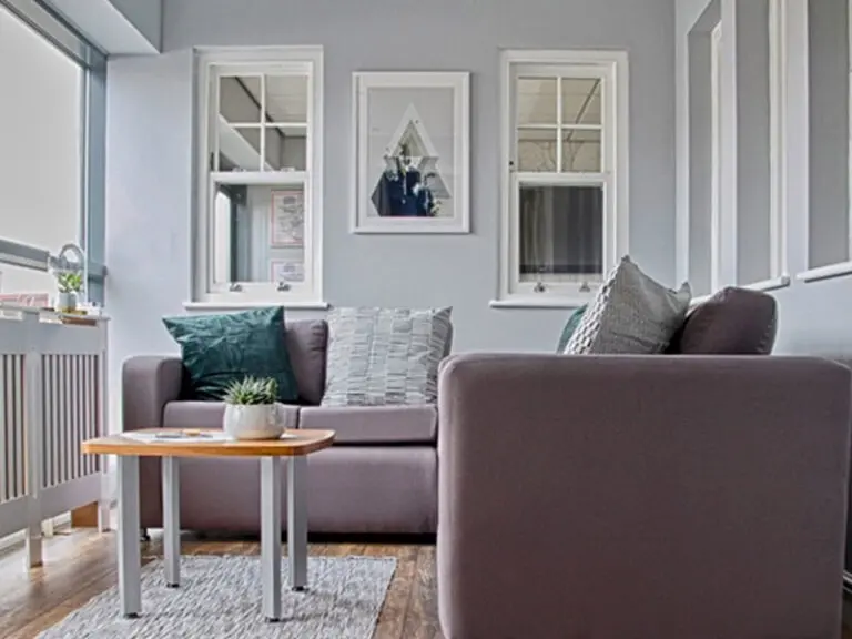 Living area with white sliding sash windows