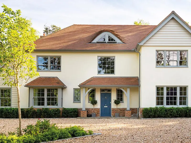 Large house with sliding sash windows and a blue entrance door
